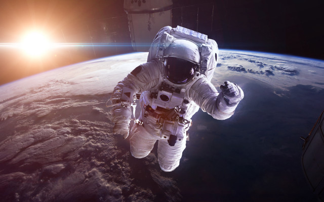 Astronaut earth horizon sun lensflare free wallpaper for desktop - medium preview image