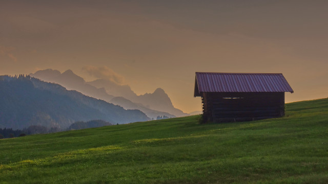 Small cabin grassy hill mountains free wallpaper for desktop - medium preview image