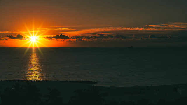 Sunset ocean boat distant lens free wallpaper for desktop - medium preview image