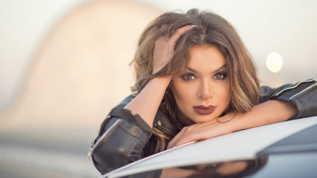 Woman leaning on car armor free wallpaper for desktop - medium preview image