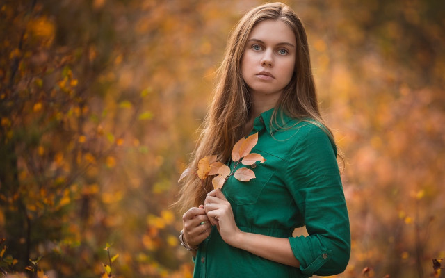 Woman green shirt holding leaf free wallpaper for desktop - medium preview image