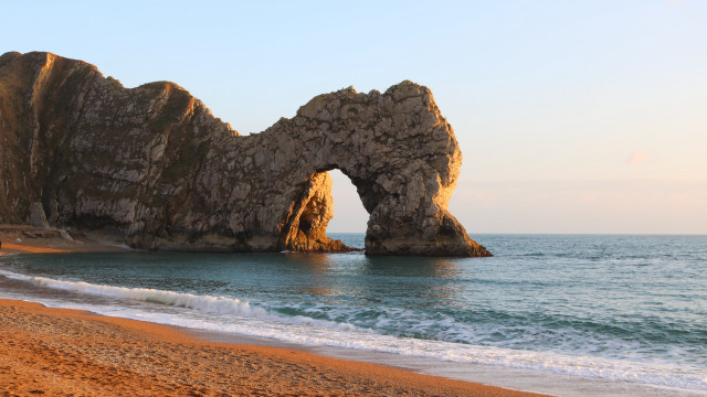 Beach rock formation waves sunset free wallpaper for desktop - medium preview image