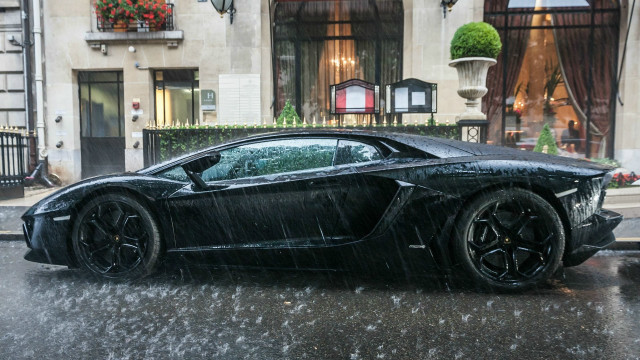 Black sports car rainy street free wallpaper for desktop - medium preview image