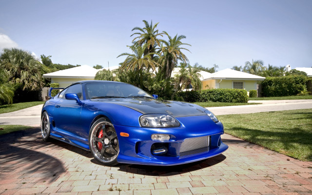 Blue sports car brick driveway free wallpaper for desktop - medium preview image
