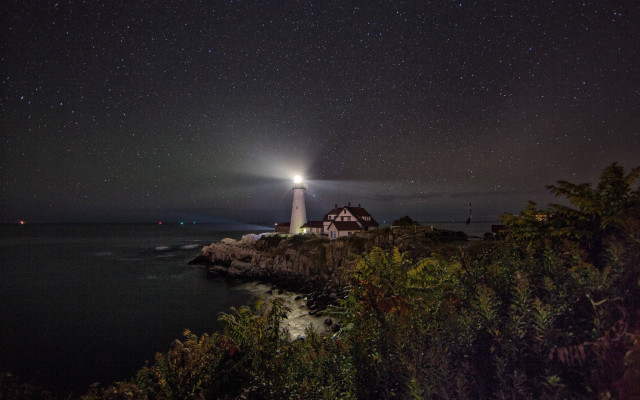 Lighthouse rocky shore night stars free wallpaper for desktop - medium preview image