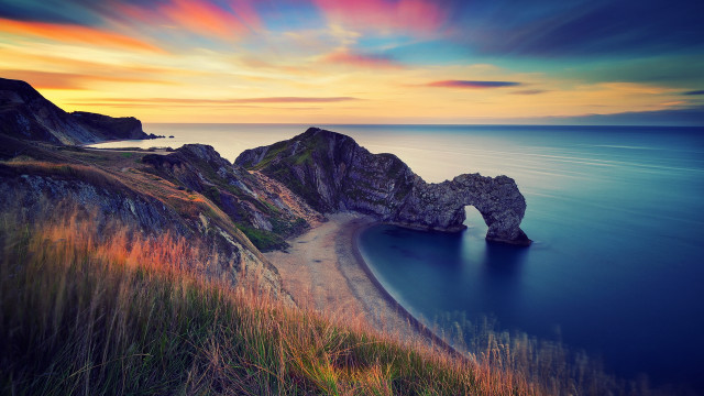 Sunset ocean rock beach landscape free wallpaper for desktop - medium preview image