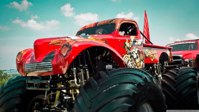 Red truck monster wheels field free wallpaper for desktop - medium preview image