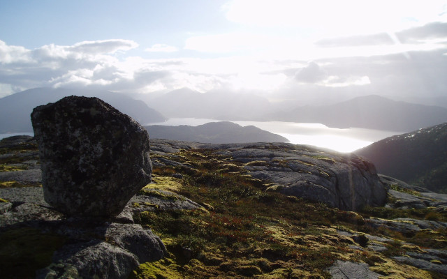 Rock formation grassy hill lake free wallpaper for desktop - medium preview image