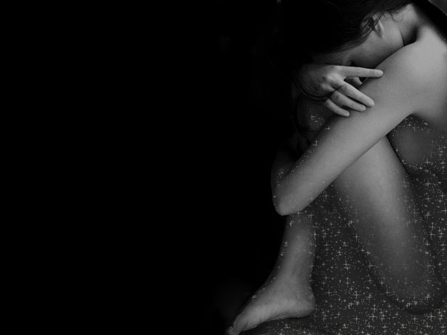 Woman hugging head dark room free wallpaper for desktop - medium preview image