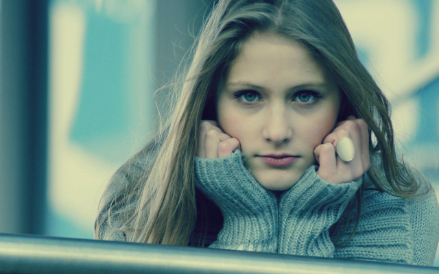 Woman longhair sweater leaning on free wallpaper for desktop - medium preview image