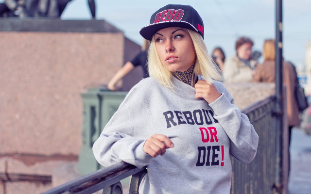 Woman hat sweatshirt leaning camera free wallpaper for desktop - medium preview image