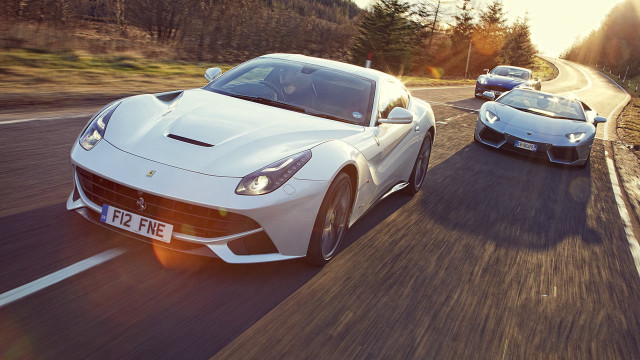 Two white sports cars driving free wallpaper for desktop - medium preview image