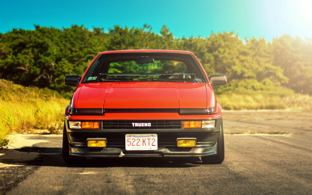 Red car forest road sky free wallpaper for desktop - medium preview image