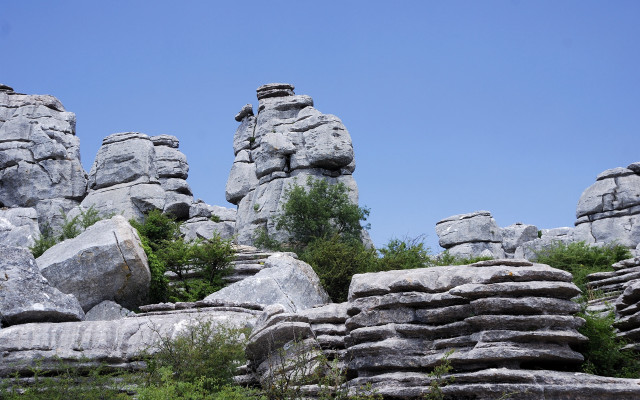 Rocky hillside trees blue sky free wallpaper for desktop - medium preview image