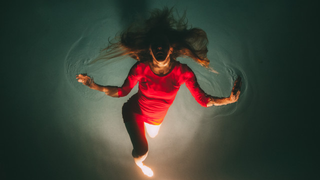Woman floating water red shirt free wallpaper for desktop - medium preview image