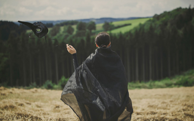 Woman black cape flying bird free wallpaper for desktop - medium preview image