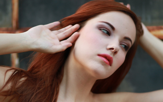 Red haired woman holding head free wallpaper for desktop - medium preview image