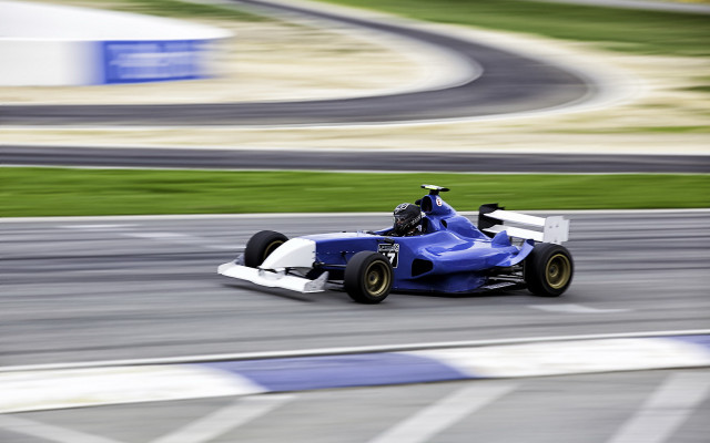 Blue white racecar driving track free wallpaper for desktop - medium preview image