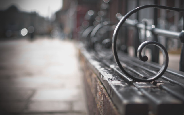 Metal bench sidewalk blurry background free wallpaper for desktop - medium preview image