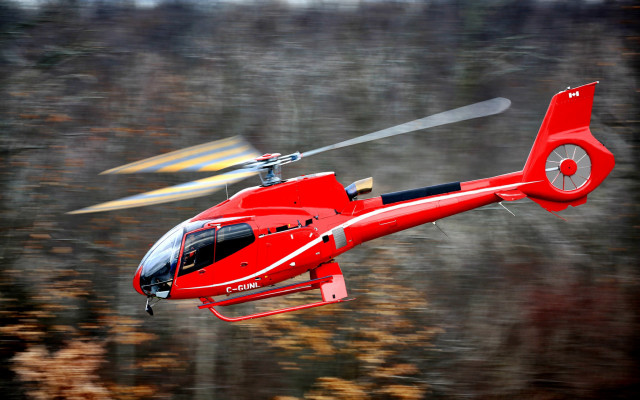 Red helicopter flying over fall free wallpaper for desktop - medium preview image