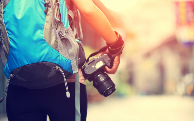 Camera backpack street buildings blurry free wallpaper for desktop - medium preview image