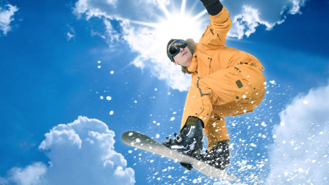 Snowboarder orange jacket air trick free wallpaper for desktop - medium preview image