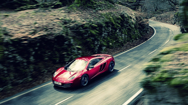 Red sports car winding forest free wallpaper for desktop - medium preview image