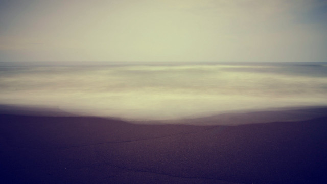 Blurry ocean beach wave sunset free wallpaper for desktop - medium preview image