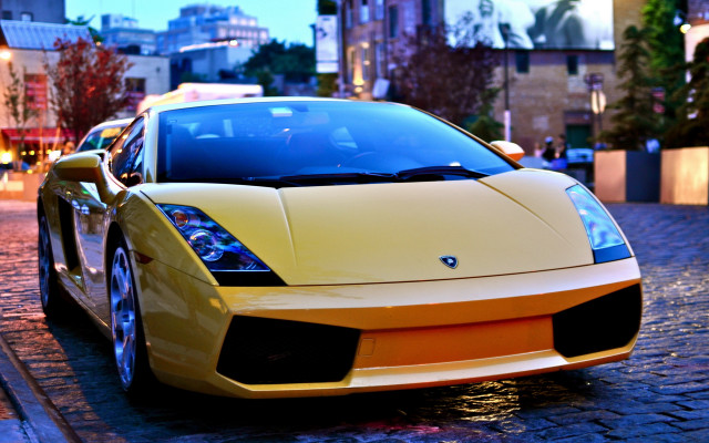 Yellow sports car city dusk free wallpaper for desktop - medium preview image