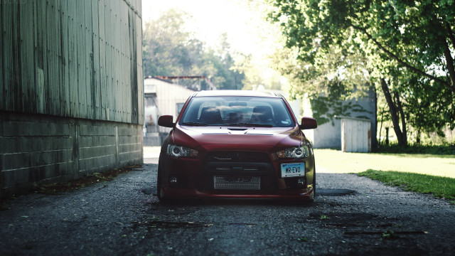 Red car building tree street free wallpaper for desktop - medium preview image