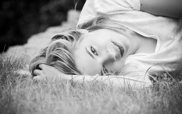 Woman lying grass outdoors monochrome free wallpaper for desktop - medium preview image