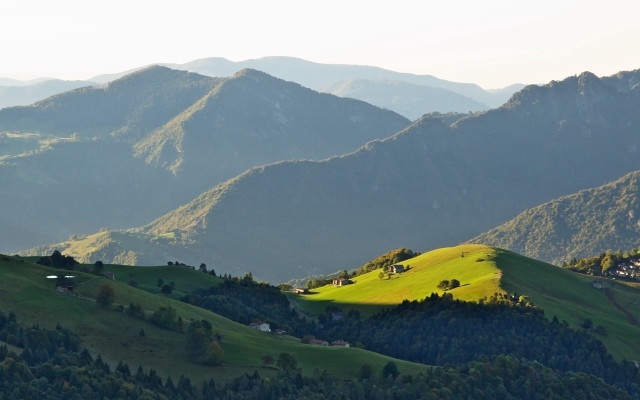 Green hillside houses mountains lake free wallpaper for desktop - medium preview image