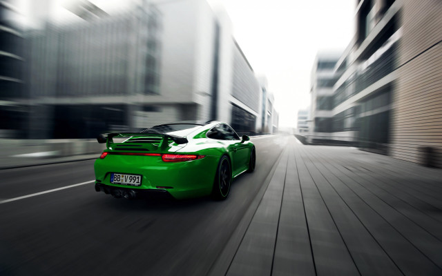 Green sports car city street #2 free wallpaper for desktop - medium preview image