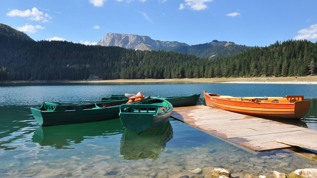 Lake mountains dock boat person free wallpaper for desktop - medium preview image