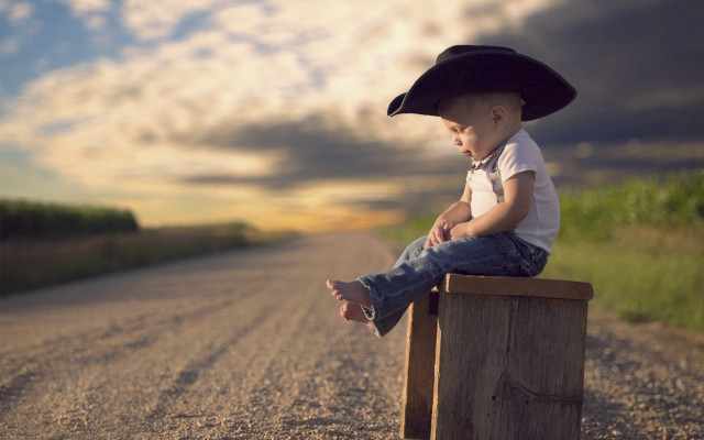 Boy hat sitting beach sunset free wallpaper for desktop - medium preview image