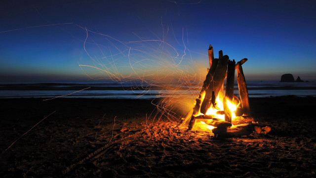 Campfire beach rock formation sunset free wallpaper for desktop - medium preview image