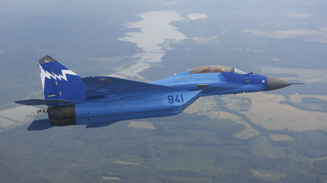 Blue fighter jet flying over free wallpaper for desktop - medium preview image