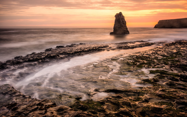 Ocean rock formation sunset beach free wallpaper for desktop - medium preview image