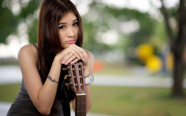 Woman tattoo guitar serious portrait free wallpaper for desktop - medium preview image