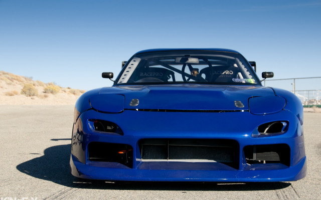 Blue sports car parking lot free wallpaper for desktop - medium preview image