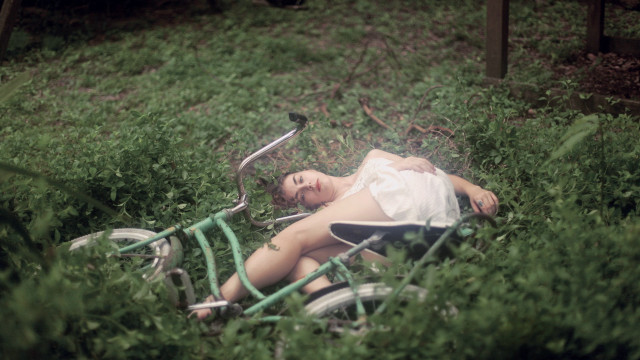 Woman bike grass overgrown nature free wallpaper for desktop - medium preview image