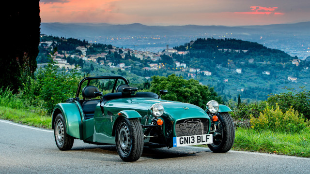 Green sports car city hills free wallpaper for desktop - medium preview image