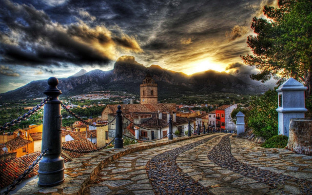 Cobblestone village clocktower mountains magic free wallpaper for desktop - medium preview image
