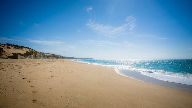 Sandy beach footprints blue sky free wallpaper for desktop - medium preview image