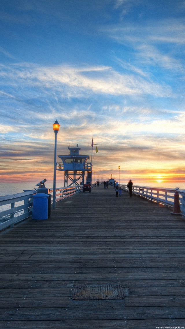 Pier light tower sunset people free wallpaper for mobile - medium preview image