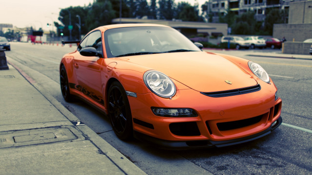 Orange sports car parked city free wallpaper for desktop - medium preview image