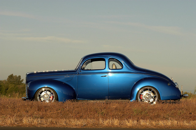 Blue car parked field grass free wallpaper for desktop - medium preview image