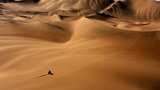 Lone person desert dune sunset free wallpaper for desktop - medium preview image