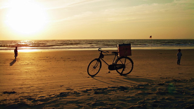 Bike beach person sunset ocean free wallpaper for desktop - medium preview image