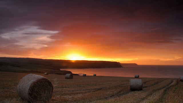 Sunset field hay bales lighthouse free wallpaper for desktop - medium preview image